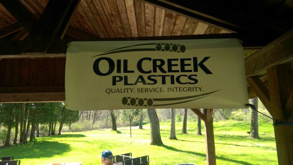 Advertising banner for Oil Creek Plastics at the 2016 Oil Creek Classic